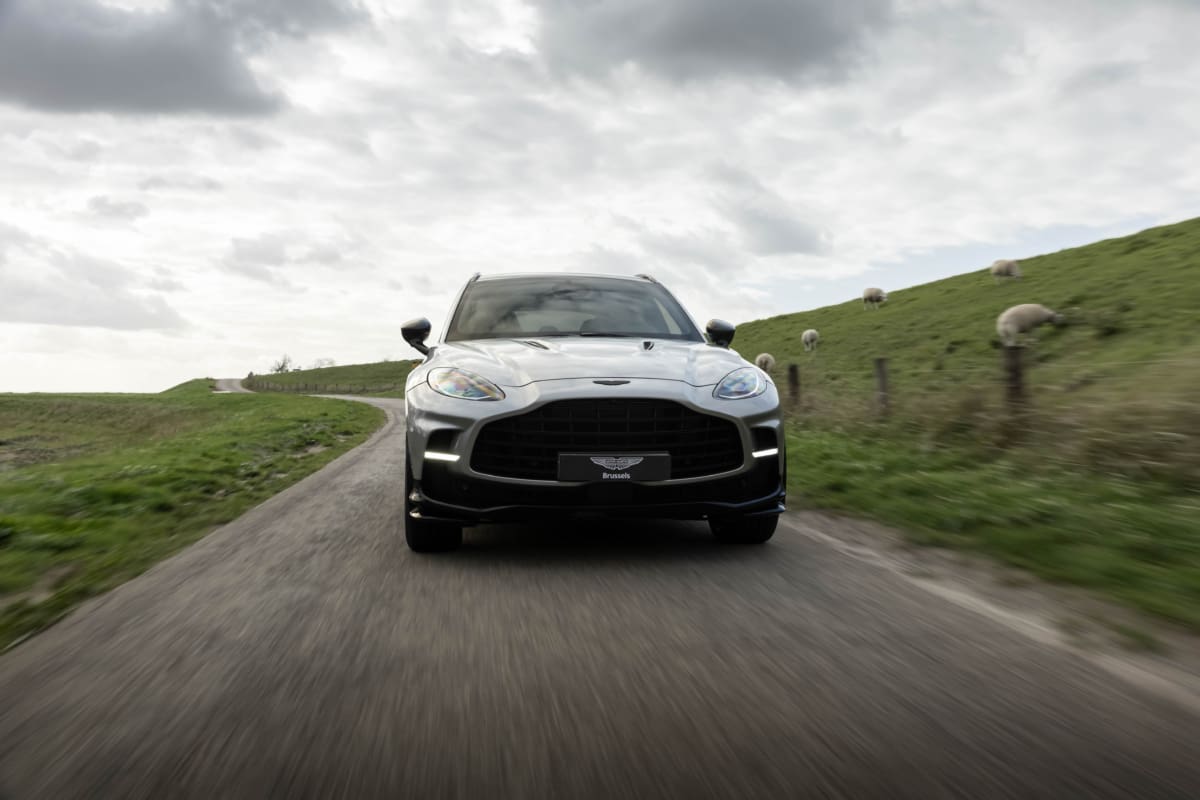 Aston Martin DBX707 driving on a countryside road aston martin brussels